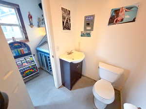 Half bath featuring vanity and toilet in GameDay/Dry Bar
