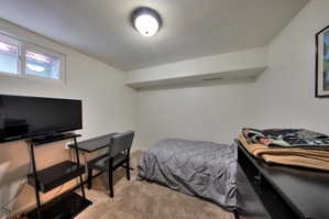 3rd Bedroom with light colored carpet and a textured ceiling
