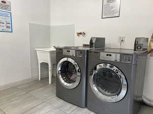 Communal laundry room with washer and dryer