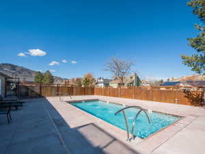 View of swimming pool with patio surround, a swimming pool, and a fenced backyard