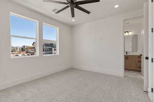 Unfurnished bedroom featuring light carpet, a ceiling fan, recessed lighting, a textured ceiling, and ensuite bathroom