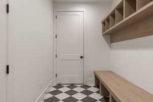 Mudroom featuring dark flooring