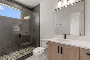 Bathroom featuring vanity, a stall shower, and marble finish flooring
