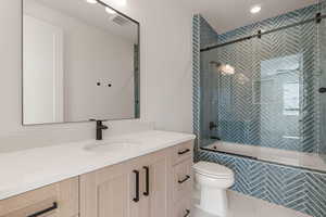 Full bathroom with tiled shower / bath and vanity