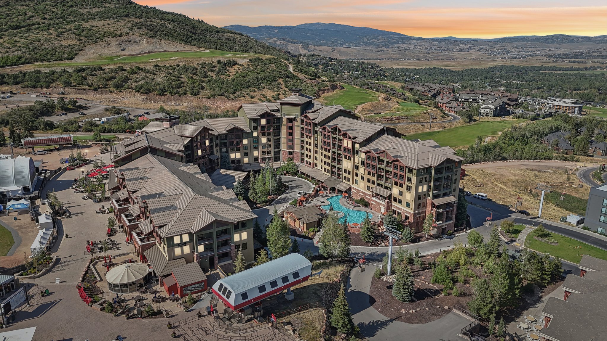 Aerial view of a mountainous background and a golf course