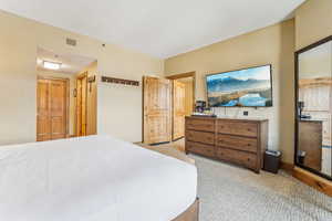 Bedroom with light colored carpet