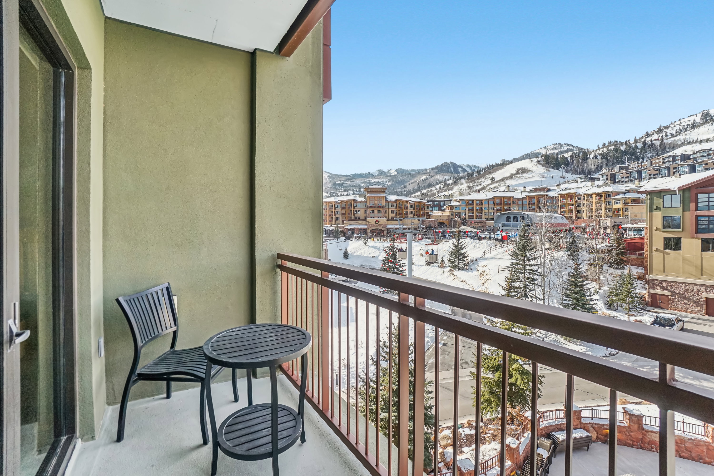 Snow covered back of property with a mountain view
