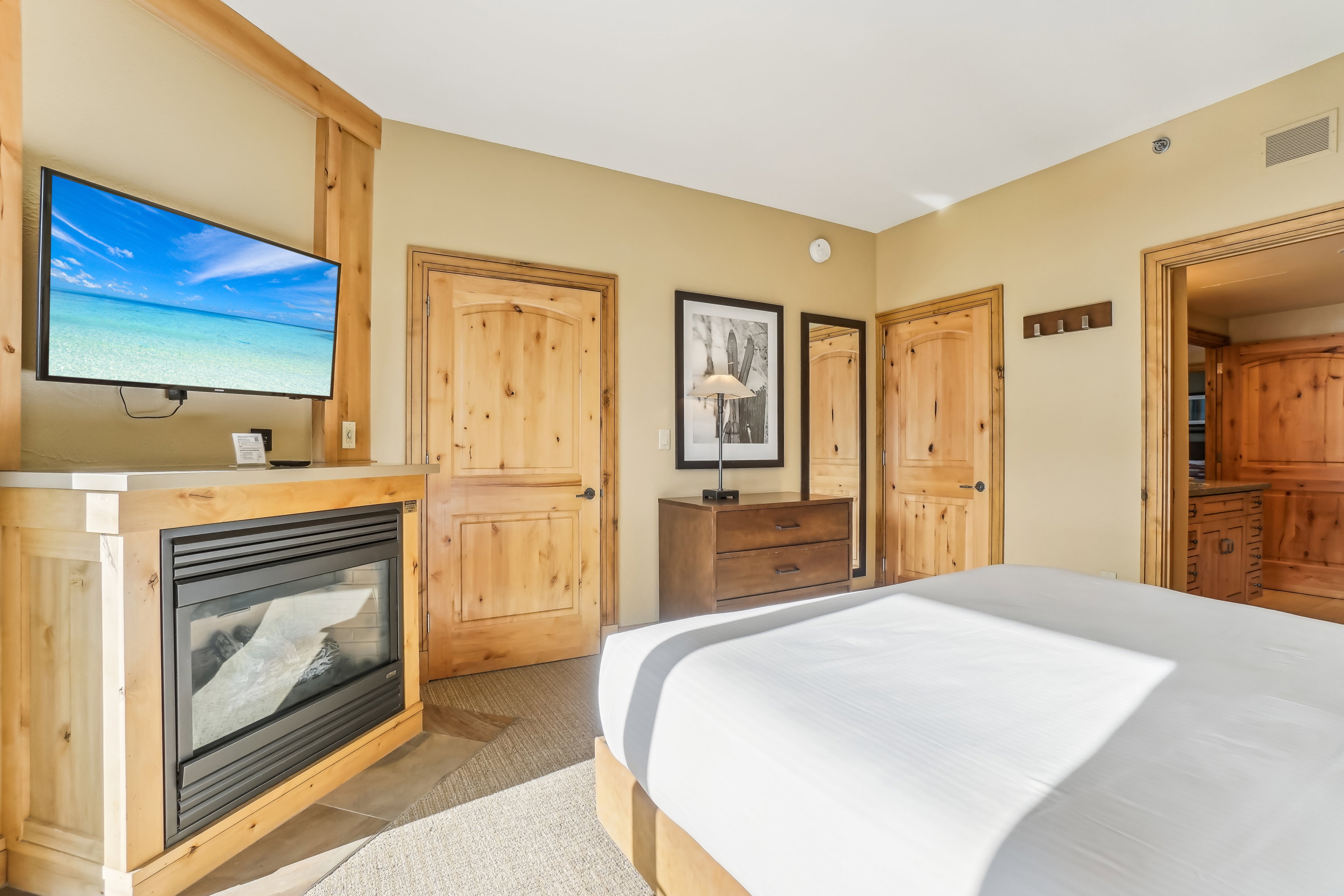Bedroom with a glass covered fireplace