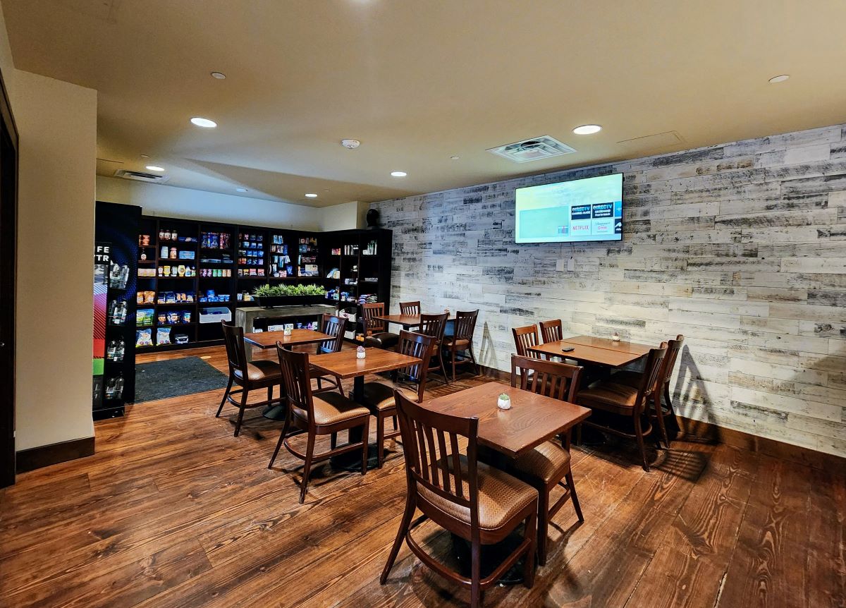 Dining room with hardwood / wood-style floors, recessed lighting, and wood walls