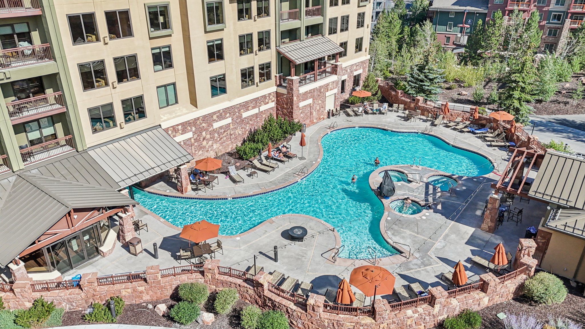 Community pool with a patio