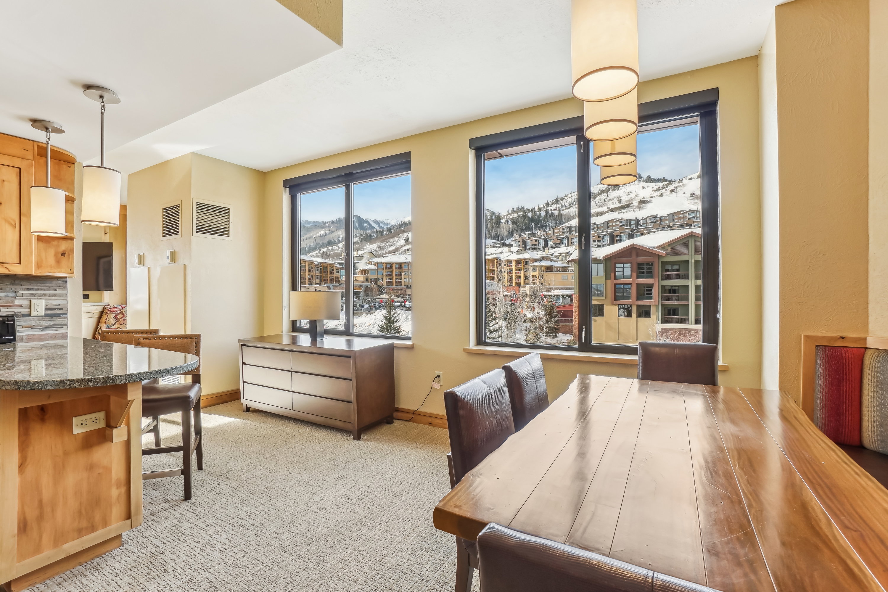 Dining room with a mountain view and light colored carpet
