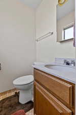 Half bath with vanity and toilet