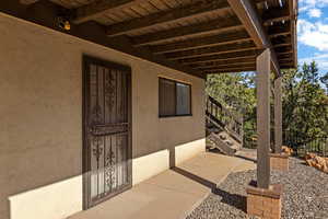 View of exterior entry featuring stucco siding