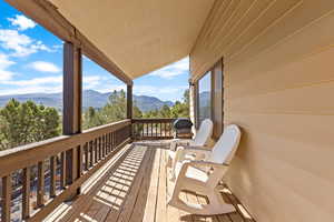 Wooden terrace featuring a mountain view