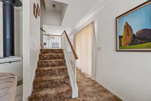 Staircase featuring a ceiling fan and baseboards