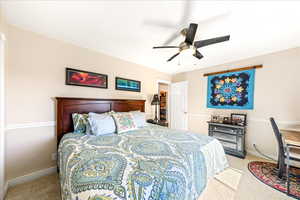 Bedroom featuring ceiling fan and light carpet