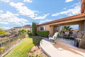 Fenced backyard featuring a patio area, a mountain view, and outdoor dining area