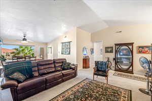 Living area featuring carpet floors and ceiling fan