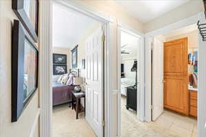 Corridor featuring light carpet