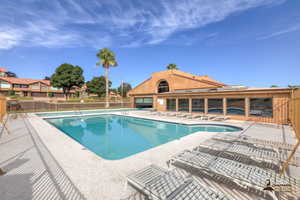 Community pool with a patio and a sunroom