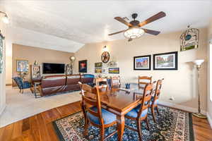 Dining room with hardwood / wood-style flooring and a ceiling fan