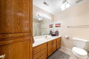 Full bath featuring vanity, an enclosed shower, and light tile patterned floors