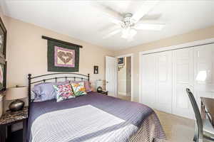 Bedroom featuring ceiling fan, a closet, and carpet flooring