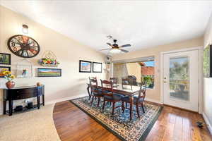 Dining area with wood-type flooring and ceiling fan