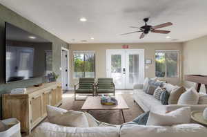 Living area featuring french doors, a ceiling fan, and recessed lighting
