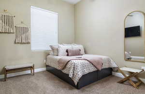 Carpeted bedroom featuring baseboards