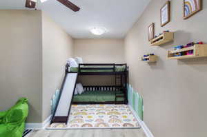 Bedroom with wood finished floors and ceiling fan