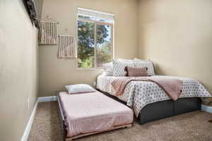 Carpeted bedroom featuring baseboards