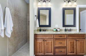 Bathroom featuring double vanity and walk in shower