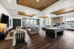 Game room with a wooden tray ceiling, billiards, a fireplace, dark wood-style floors, and recessed lighting