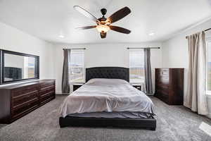 Bedroom featuring carpet, ceiling fan, and a textured ceiling