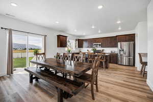 Dining area with a mountain view, light wood-style flooring, and recessed lighting