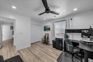 Office featuring light wood-style flooring, a ceiling fan, and recessed lighting