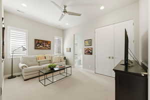 Living area featuring light carpet, recessed lighting, ceiling fan, and plenty of natural light
