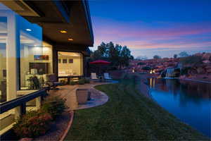 View of green lawn with a patio