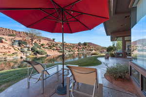 View of patio with a water and mountain view