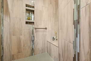 Full bathroom featuring a tile shower