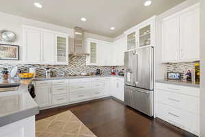 Kitchen featuring stainless steel appliances, white cabinets, glass insert cabinets, and recessed lighting