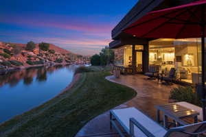 View of grassy yard with a patio area and a water and mountain view