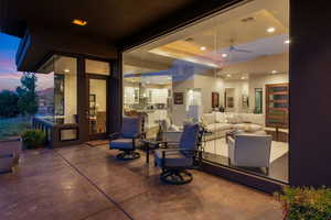 View of patio with an outdoor living space and ceiling fan