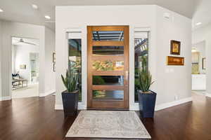Entrance foyer with recessed lighting and dark wood-type flooring