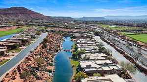 Aerial perspective of suburban area with a water and mountain view and a local golf course