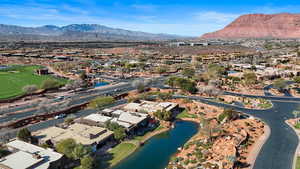 Aerial overview of property's location with a water and mountain view and nearby suburban area