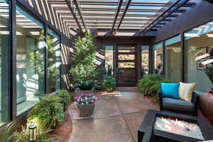 View of patio / terrace with a fire pit and a pergola