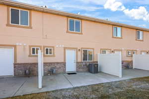 Back of property featuring a patio area and stucco siding