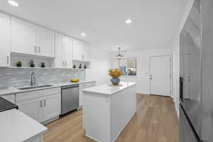Kitchen featuring NEW soft close white cabinets, a NEW kitchen island, open shelves, and Luxury LPV Vinyl flooring